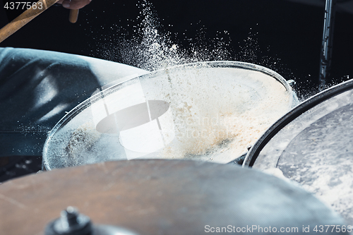 Image of Drummer rehearsing on drums before rock concert. Man recording music on drum set in studio