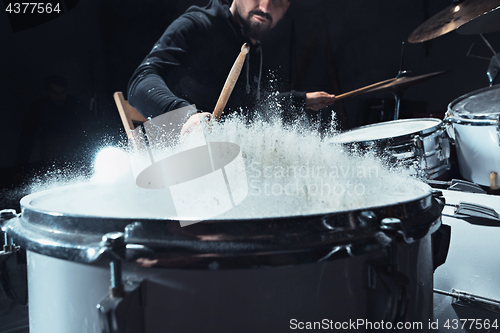 Image of Drummer rehearsing on drums before rock concert. Man recording music on drum set in studio