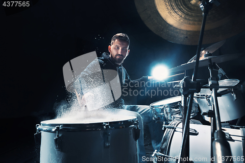 Image of Drummer rehearsing on drums before rock concert. Man recording music on drum set in studio