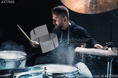 Image of Drummer rehearsing on drums before rock concert. Man recording music on drum set in studio