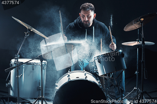 Image of Drummer rehearsing on drums before rock concert. Man recording music on drum set in studio