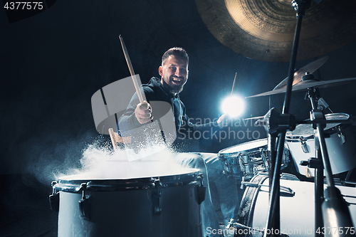 Image of Drummer rehearsing on drums before rock concert. Man recording music on drum set in studio