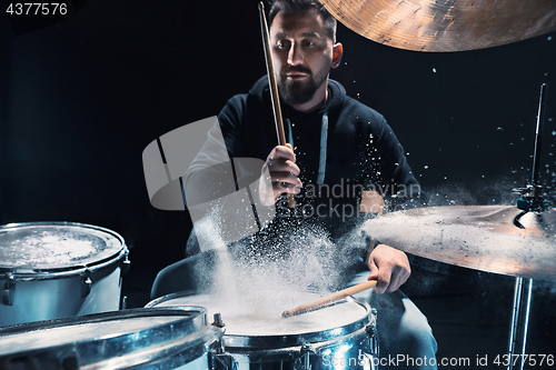 Image of Drummer rehearsing on drums before rock concert. Man recording music on drum set in studio