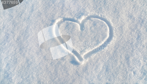 Image of Draw of heart on the white snow 