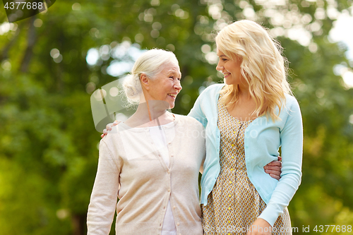 Image of daughter with senior mother hugging at park