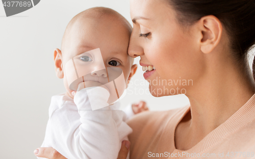 Image of happy mother with little baby boy at home