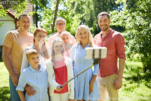 Image of happy family taking selfie in summer garden