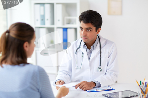 Image of doctor giving prescription to patient at hospital