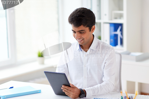 Image of businessman working with tablet pc at office