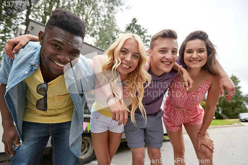 Image of group of happy friends hugging at food truck