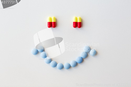 Image of smiley of different pills and capsules of drugs