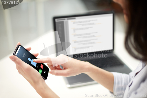 Image of close up of woman with smartphone at office