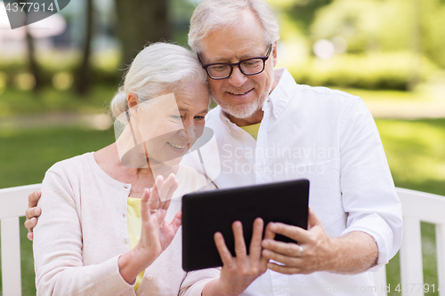 Image of senior couple with video chat on tablet pc at park