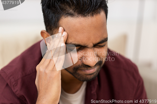 Image of close up of man suffering from head ache at home