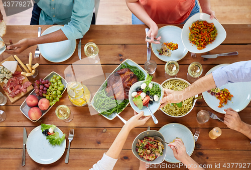 Image of group of people eating at table with food