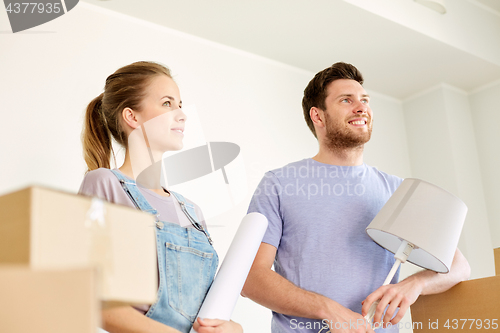 Image of couple with boxes and lamp moving to new home