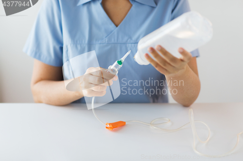 Image of close up of nurse preparing drop counter