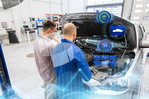 Image of auto mechanic and man or car owner at workshop