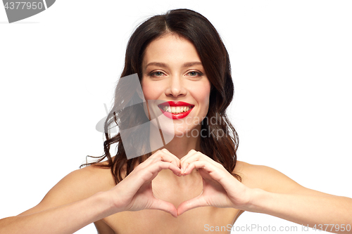 Image of beautiful woman with red lipstick and hand heart