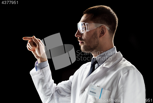 Image of doctor or scientist in lab coat and safety glasses