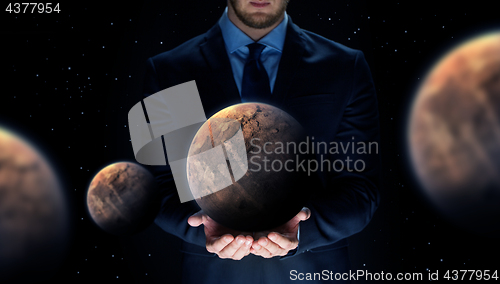 Image of close up of businessman with planet hologram