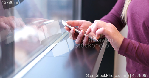 Image of Close up of business woman using cell phone in office interior