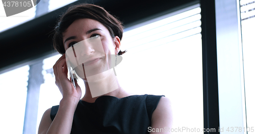 Image of Business Girl Standing In A Modern Building Near The Window With