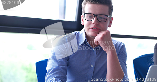 Image of young businessman in startup office