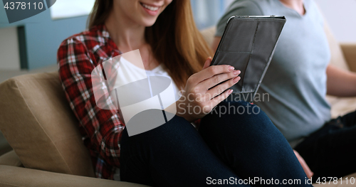 Image of Young Couple using digital tablet at home