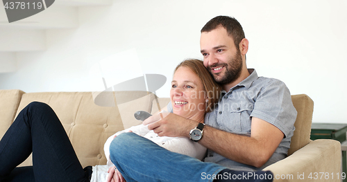 Image of senoior couple watching tv in modern villa