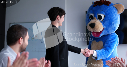 Image of boss dresed as bear having fun with business people in trendy of