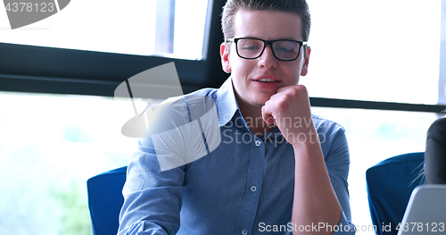 Image of young businessman in startup office