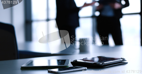 Image of tablet, mobile cell phone and cup of coffee  in office with busi