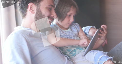 Image of Father Daughter using Tablet in modern apartment