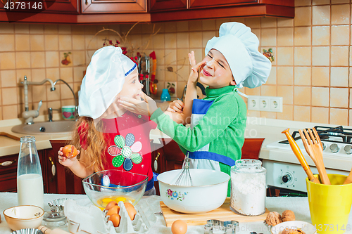 Image of happy family funny kids are preparing the dough, bake cookies in the kitchen