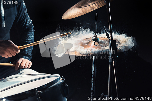 Image of Drummer rehearsing on drums before rock concert. Man recording music on drum set in studio