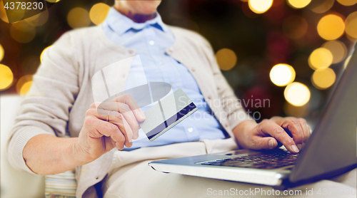 Image of senior woman with laptop and credit card