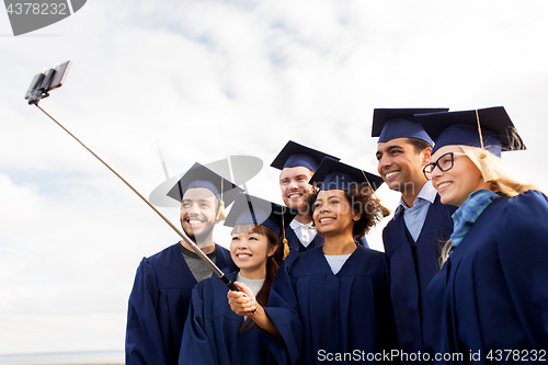 Image of group of happy students or graduates taking selfie