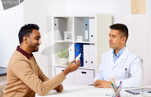 Image of doctor and patient with nasal spray at hospital