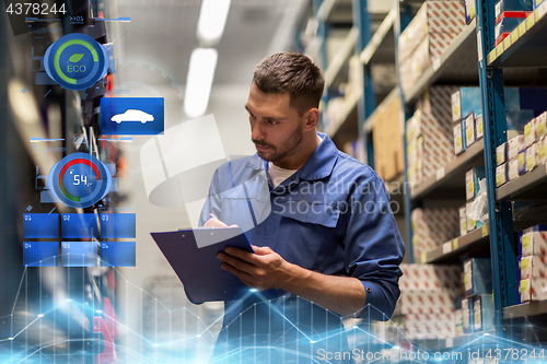 Image of auto mechanic with clipboard at car workshop