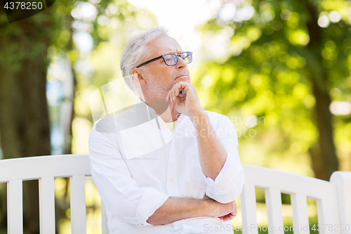 Image of thoughtful senior man at summer park