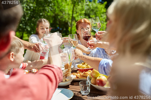 Image of happy family having dinner or summer garden party