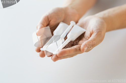 Image of hand holding tubes of micro enema