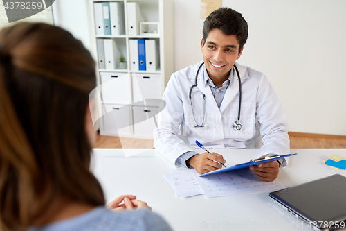 Image of doctor with clipboard and patient at hospital