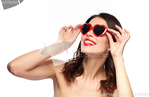 Image of woman with red lipstick and heart shaped shades