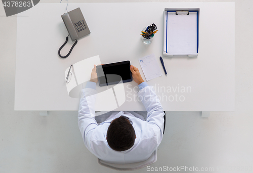 Image of doctor with tablet pc and prescription at clinic