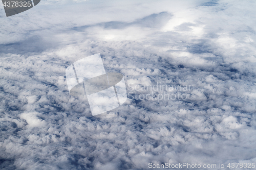 Image of Sunrise above clouds from airplane window