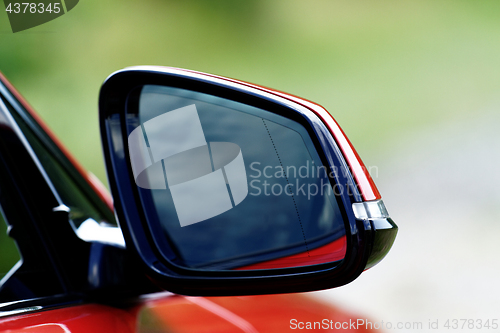 Image of Red sports car rearview mirror