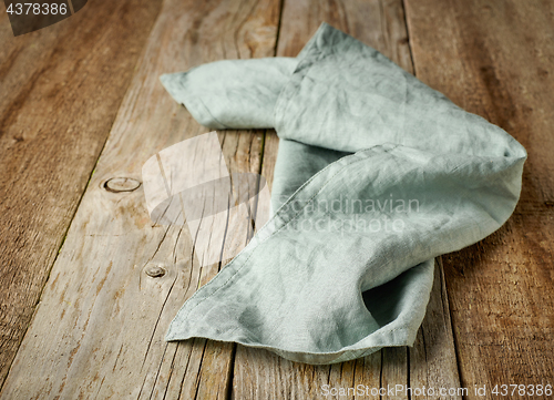 Image of linen napkin on wooden background