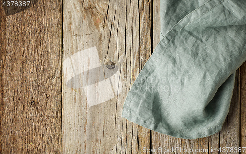 Image of linen napkin on wooden background